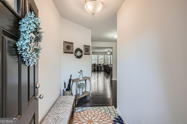 hall with hardwood / wood-style floors