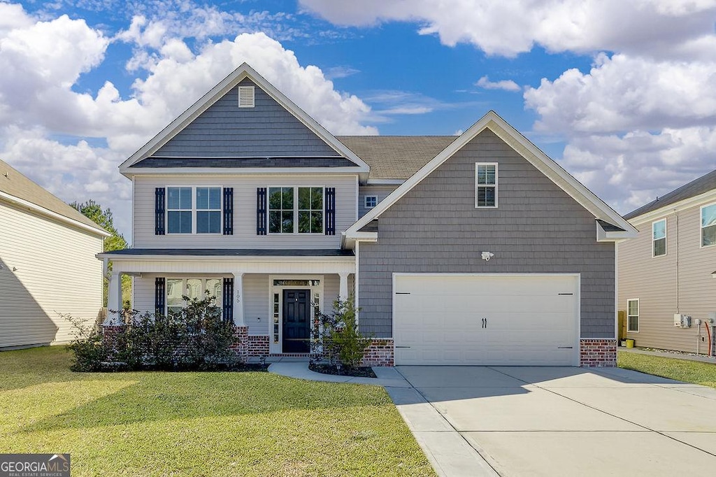 view of front facade with a front lawn, a garage, and a porch