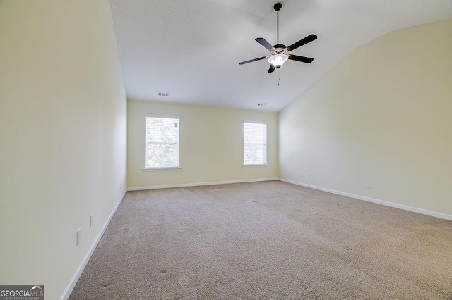 empty room with ceiling fan, light carpet, and lofted ceiling