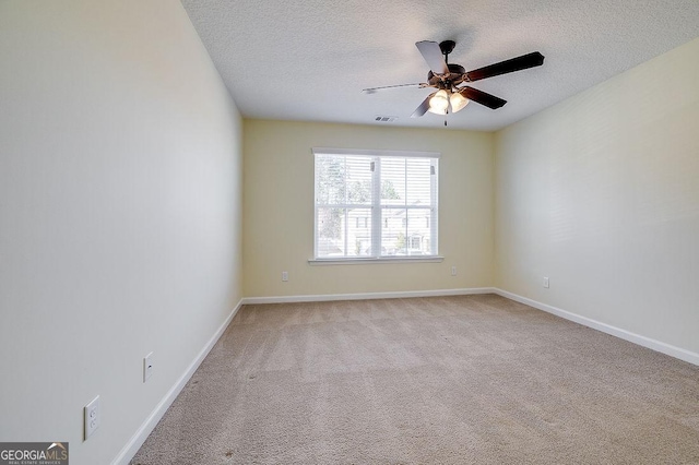 unfurnished room with light carpet, ceiling fan, and a textured ceiling