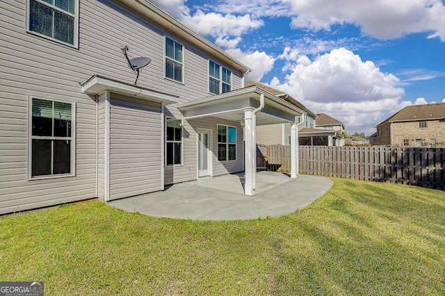 back of house featuring a yard and a patio