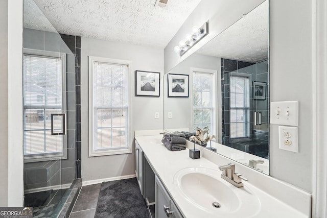 bathroom with vanity, tile patterned flooring, and a textured ceiling