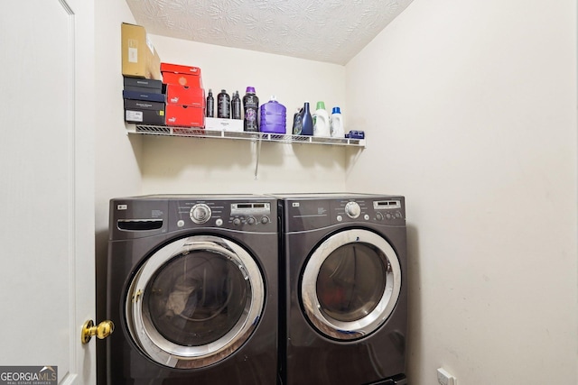 clothes washing area featuring independent washer and dryer and a textured ceiling