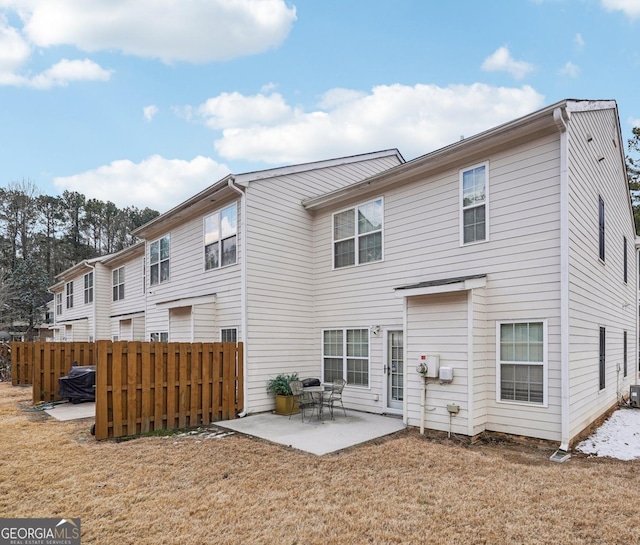 back of house with a patio area and a lawn