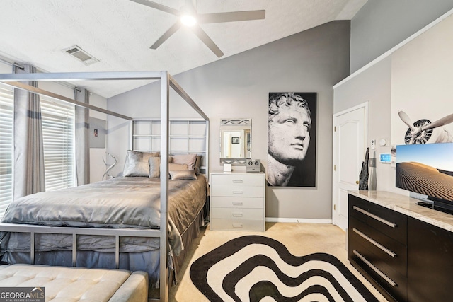 bedroom with lofted ceiling, a textured ceiling, light colored carpet, and ceiling fan