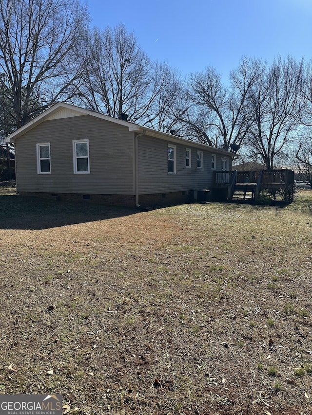 exterior space featuring a wooden deck and a yard