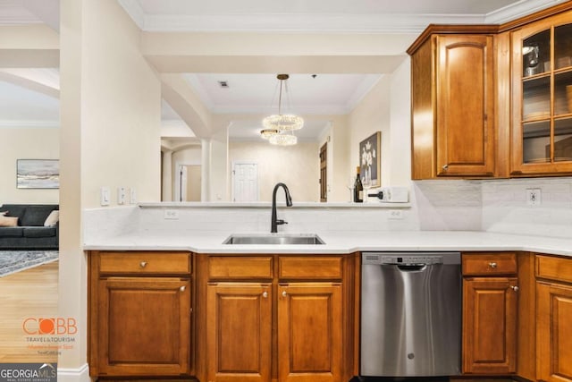 kitchen featuring a sink, light countertops, glass insert cabinets, stainless steel dishwasher, and backsplash