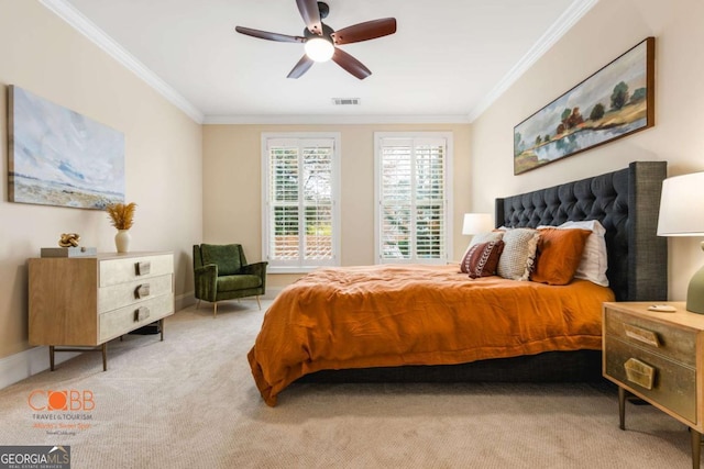 bedroom featuring visible vents, light colored carpet, ornamental molding, and a ceiling fan