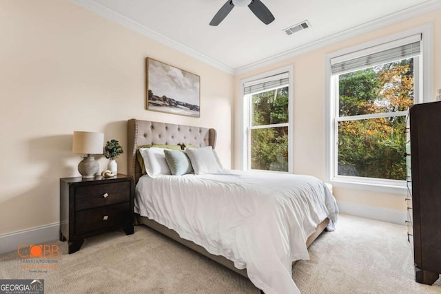 bedroom with a ceiling fan, baseboards, visible vents, light carpet, and crown molding