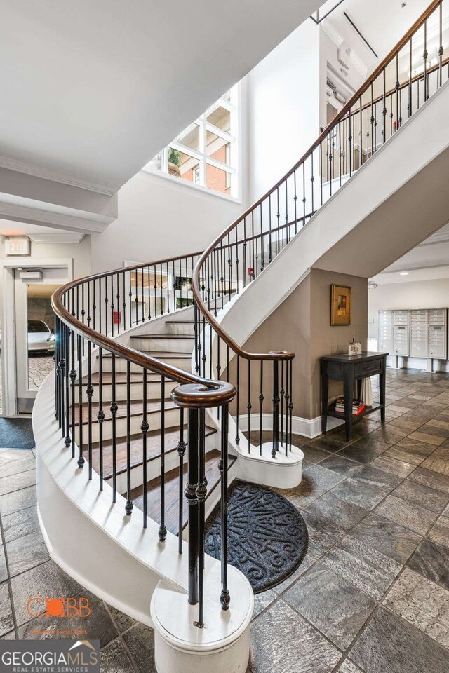 staircase featuring a high ceiling