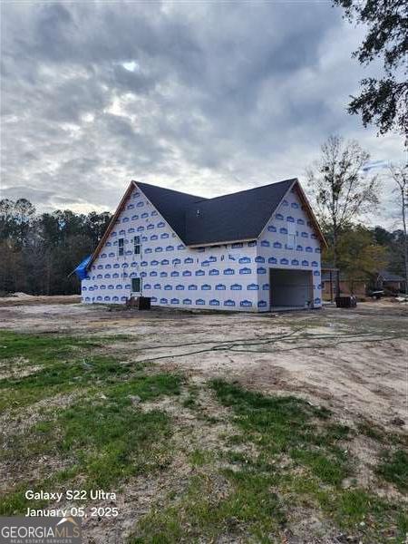 view of side of home featuring a garage