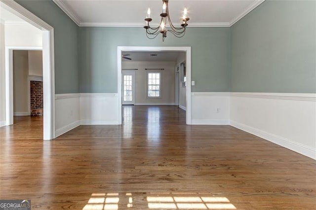 interior space featuring an inviting chandelier, dark hardwood / wood-style flooring, and crown molding