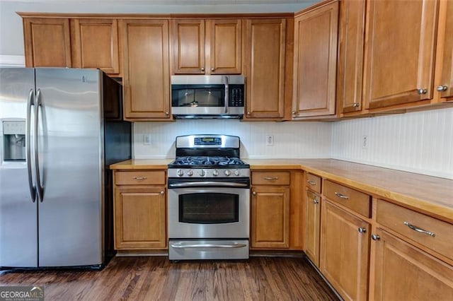 kitchen featuring appliances with stainless steel finishes and dark hardwood / wood-style floors