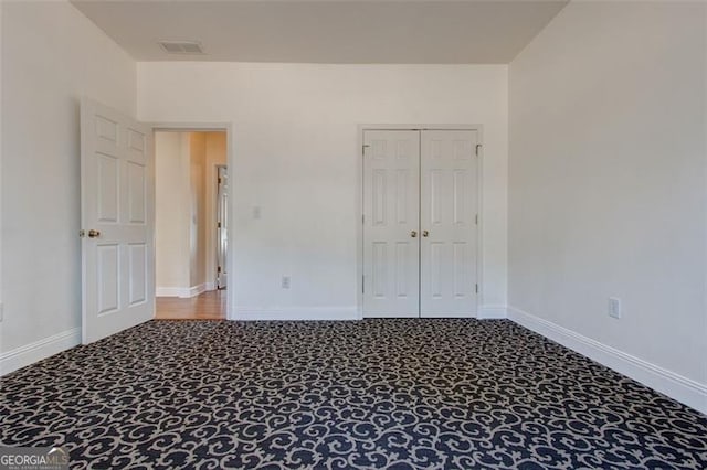 unfurnished bedroom with carpet floors and a closet