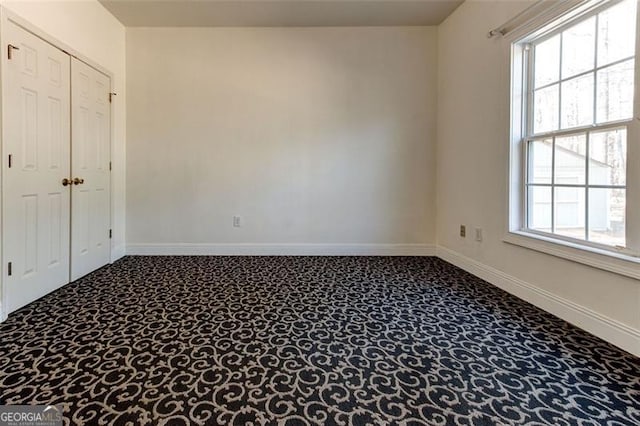 unfurnished room with carpet and a healthy amount of sunlight