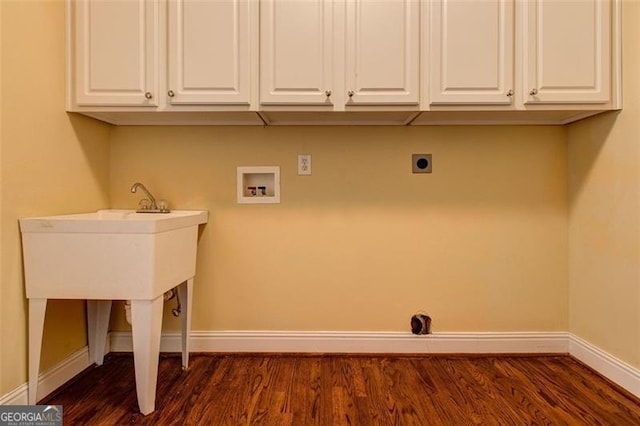 laundry area with cabinets, electric dryer hookup, washer hookup, and dark hardwood / wood-style flooring