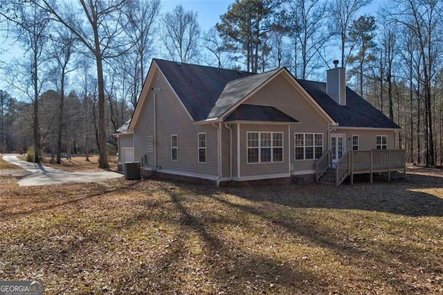 back of property featuring central air condition unit and a deck