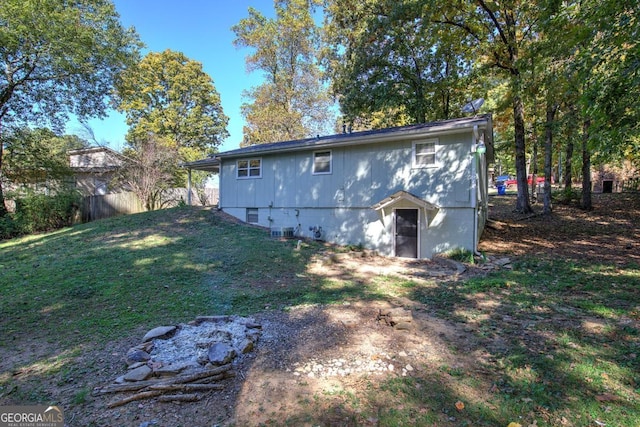 rear view of property with a lawn