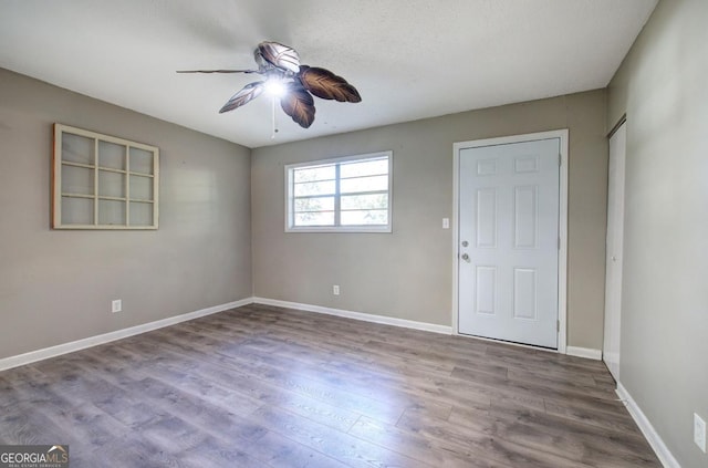 empty room with a textured ceiling, ceiling fan, and hardwood / wood-style flooring