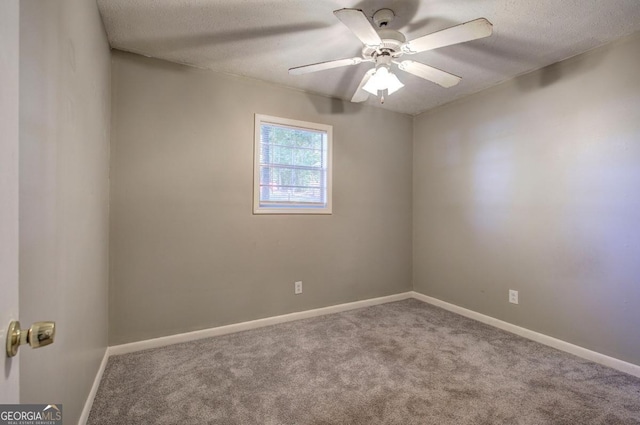 carpeted spare room with ceiling fan and a textured ceiling