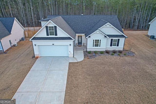 view of front of house featuring cooling unit and a garage