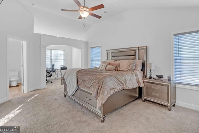 carpeted bedroom featuring ceiling fan, connected bathroom, and high vaulted ceiling