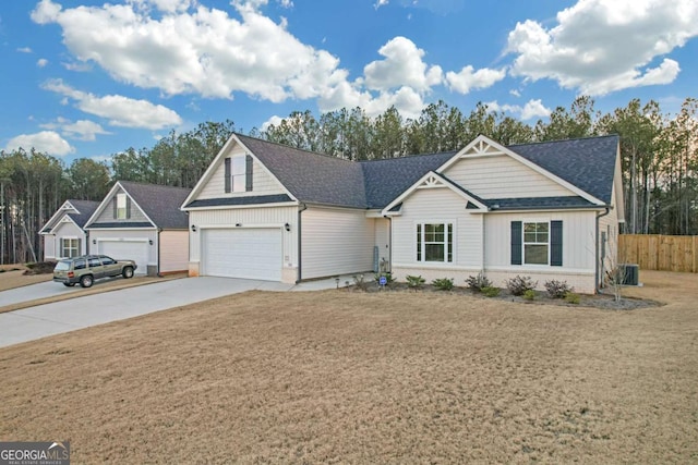 single story home with a garage, cooling unit, and a front lawn