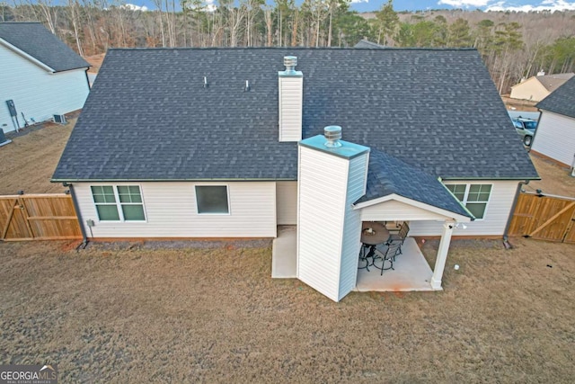 back of house featuring a patio area and a yard