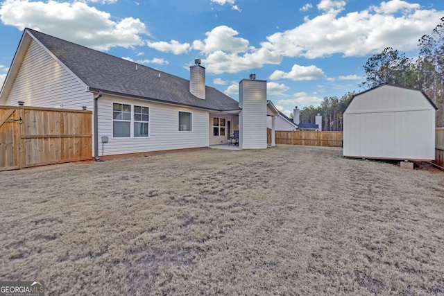 back of property with a patio and a shed