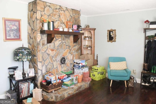 living room with hardwood / wood-style flooring and crown molding