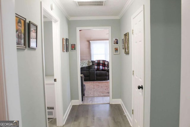 hall featuring hardwood / wood-style floors and ornamental molding