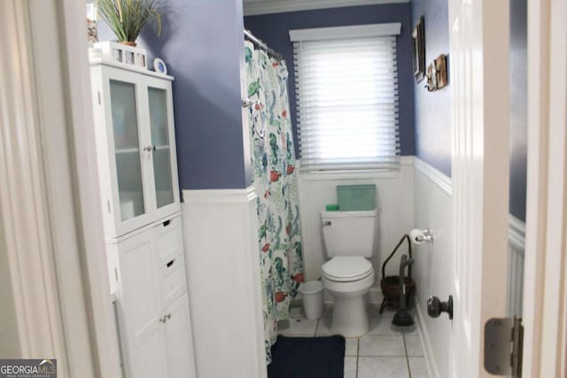 bathroom with toilet and tile patterned floors