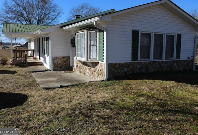 view of side of property with a yard