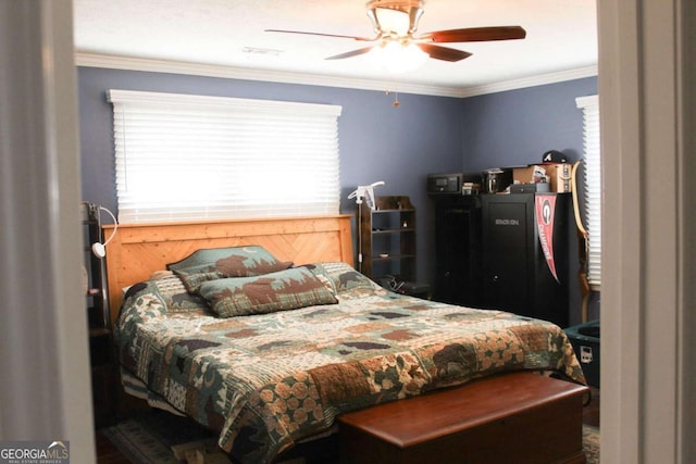 bedroom featuring ceiling fan and crown molding