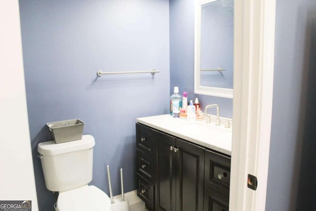 bathroom with toilet and vanity