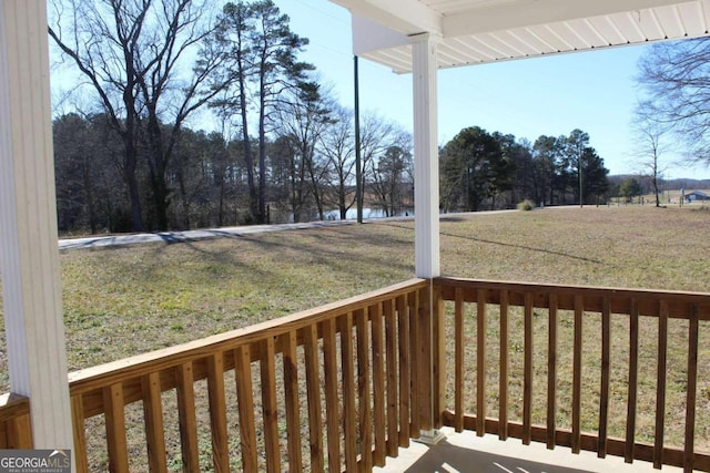 wooden terrace featuring a yard