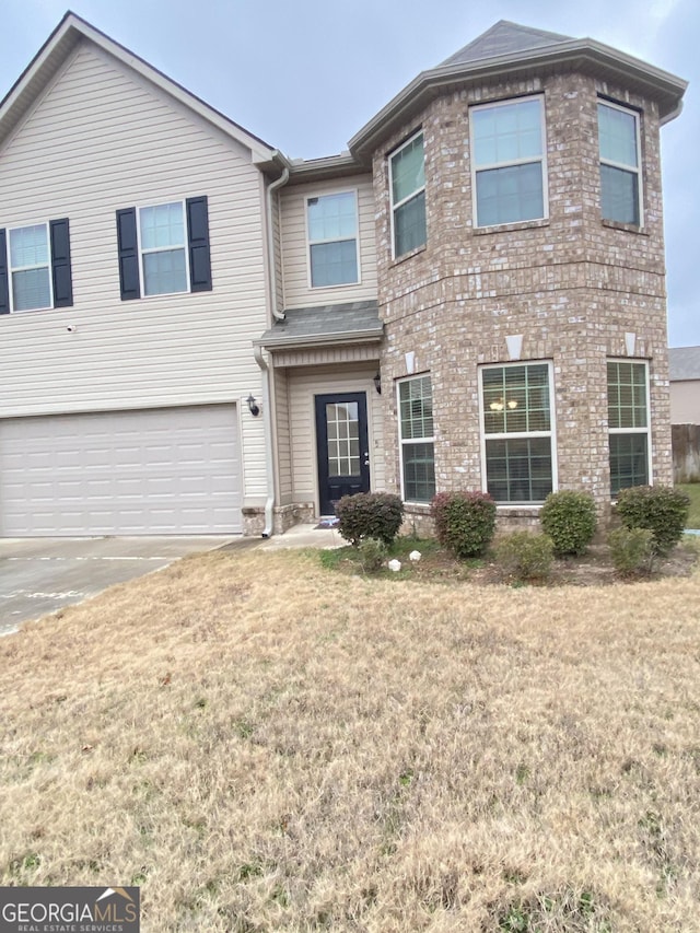 view of front facade with a garage and a front yard