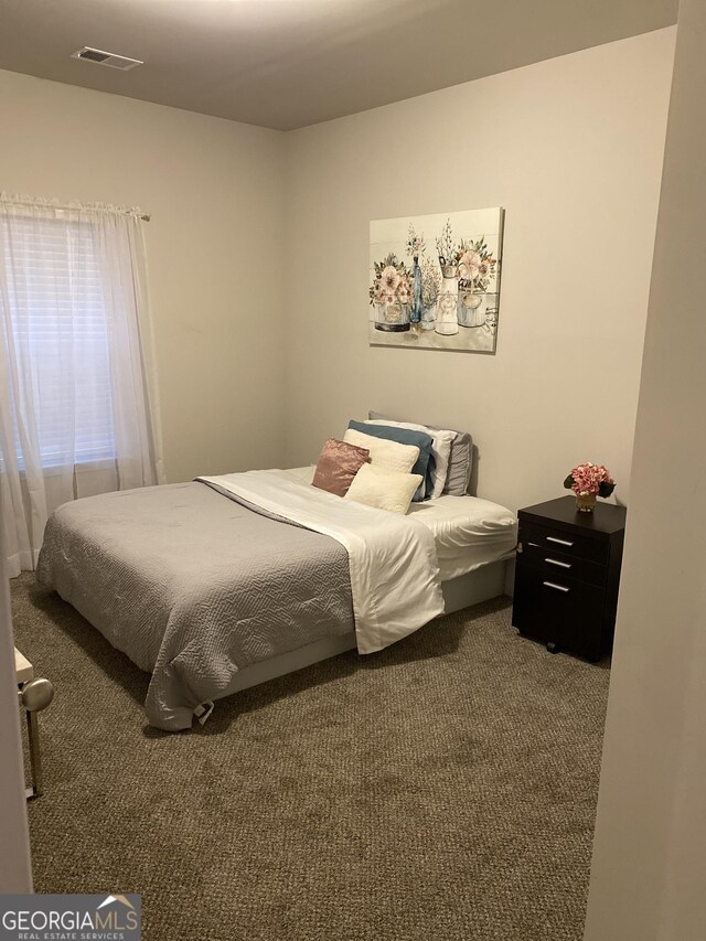 bedroom featuring dark colored carpet