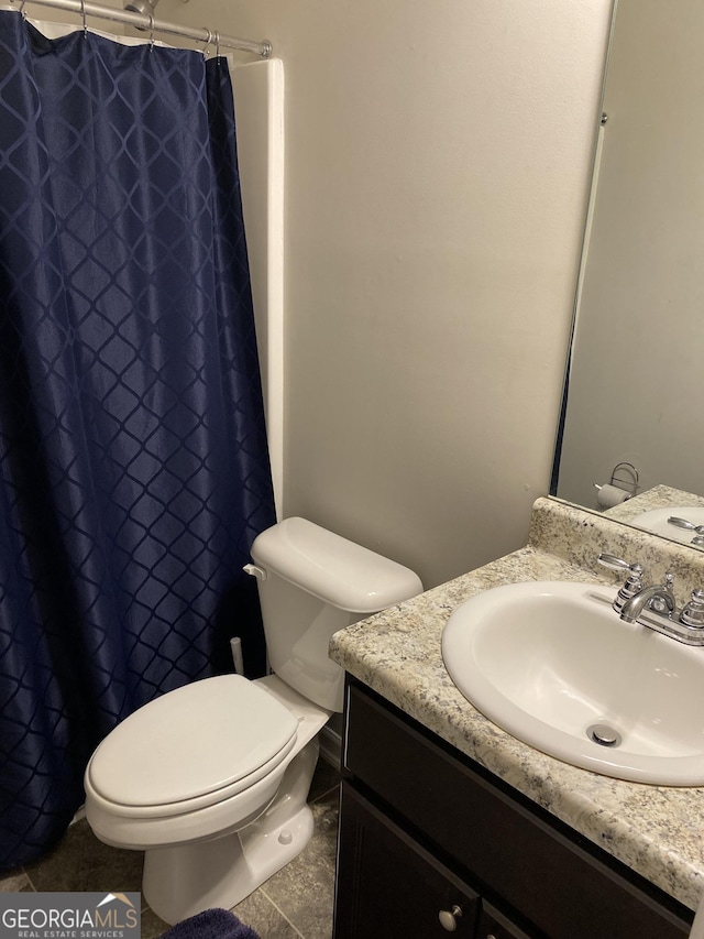 bathroom with vanity, a shower with curtain, tile patterned floors, and toilet