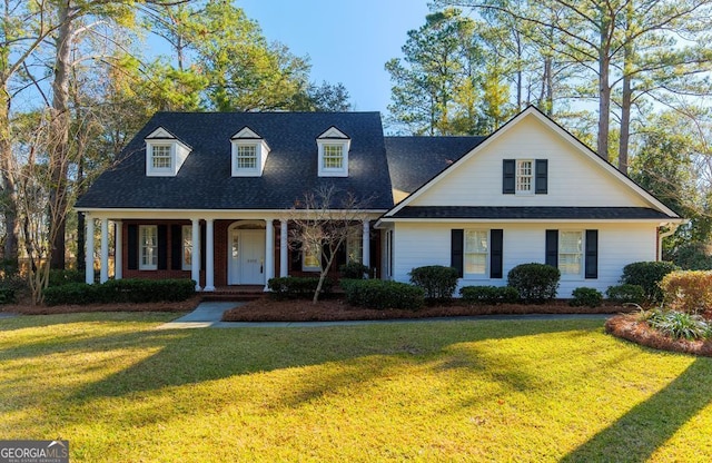 new england style home featuring a front lawn