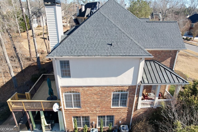 rear view of property with a wooden deck