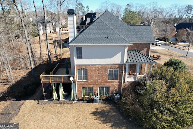 rear view of property featuring a deck