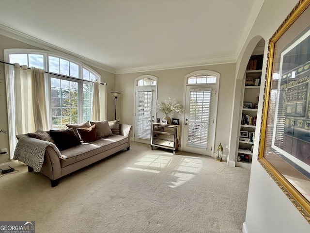 sitting room with crown molding and light colored carpet