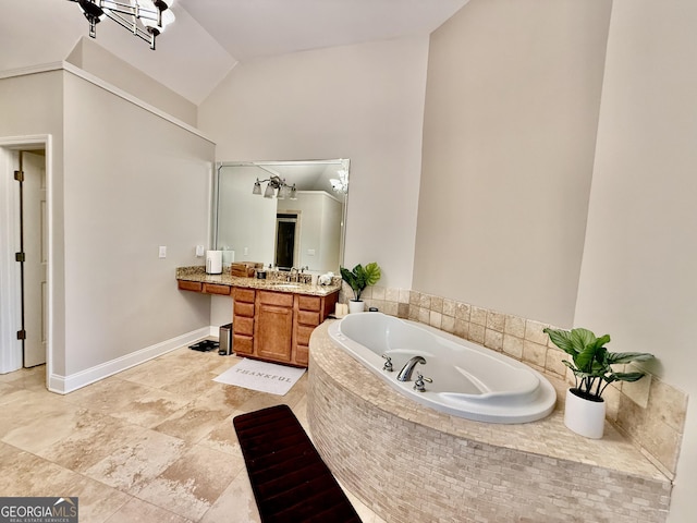 bathroom featuring lofted ceiling, vanity, and a relaxing tiled tub