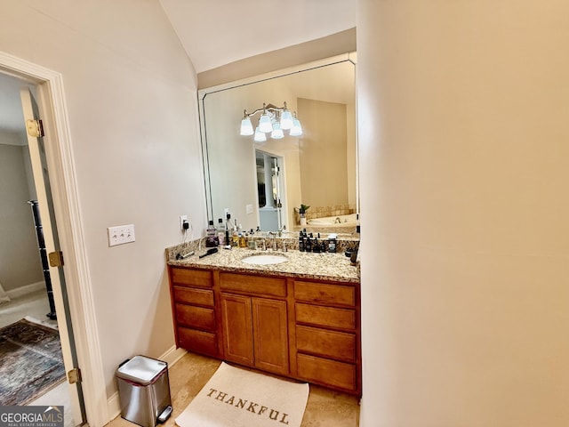 bathroom featuring vanity and vaulted ceiling