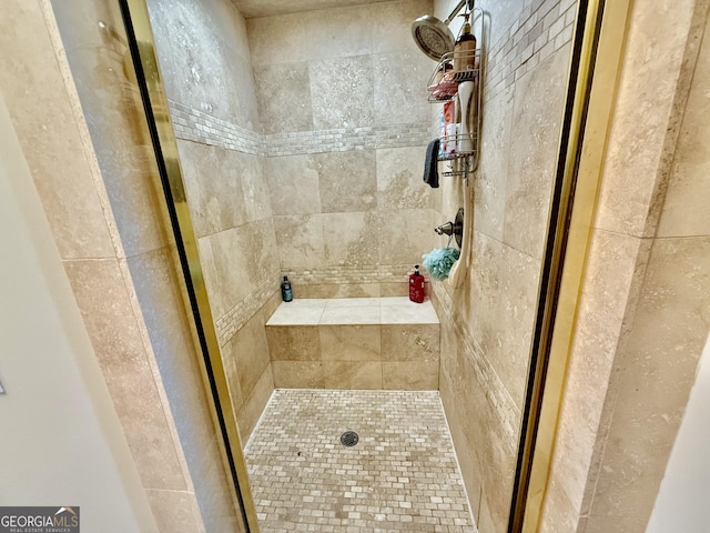 bathroom with tiled shower