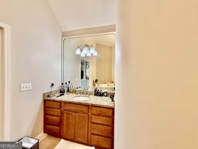 bathroom with wood-type flooring, vanity, and vaulted ceiling