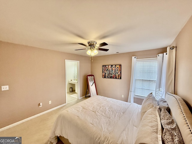 bedroom with light carpet, ceiling fan, and ensuite bathroom