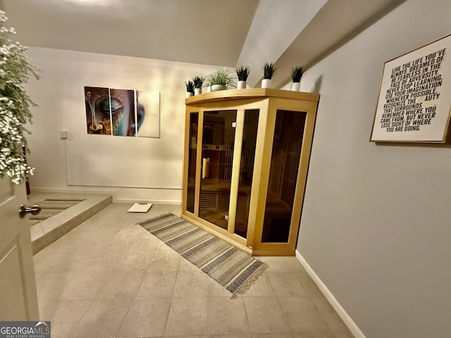 hallway with tile patterned floors