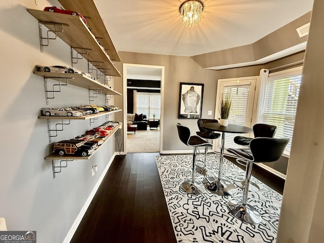 home office featuring dark hardwood / wood-style flooring and a chandelier